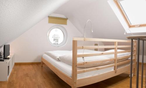 a bedroom with a bunk bed and a window at Landhaus Residenz Kirchsee Morgenstern in Insel Poel