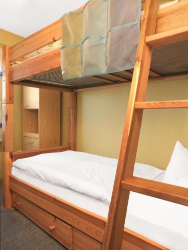 a bedroom with two bunk beds with white sheets at Haus Otto in Insel Poel