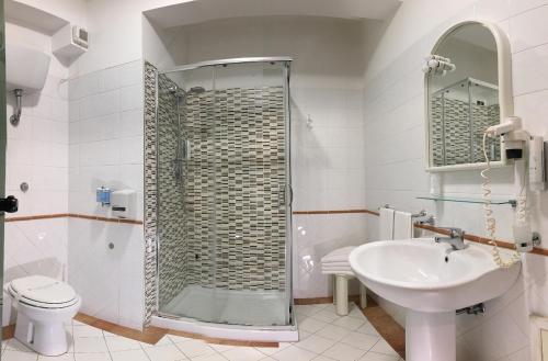 a bathroom with a shower and a sink and a toilet at Hotel Federica in Riace Marina