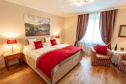 
a bedroom with a large bed and a large window at Donauhof - Hotel garni in Weissenkirchen in der Wachau
