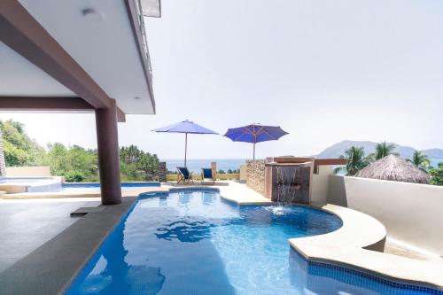 a swimming pool in the middle of a house at Grand View Suites in Manzanillo
