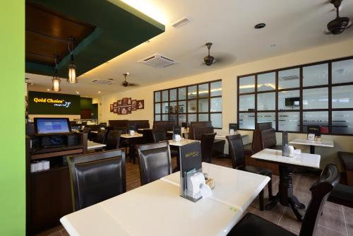 a fast food restaurant with tables and chairs at Grand Inn - Penang Road in George Town