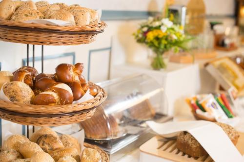 two baskets of bread on a counter in a bakery at Strandhotel Löchnerhaus in Reichenau