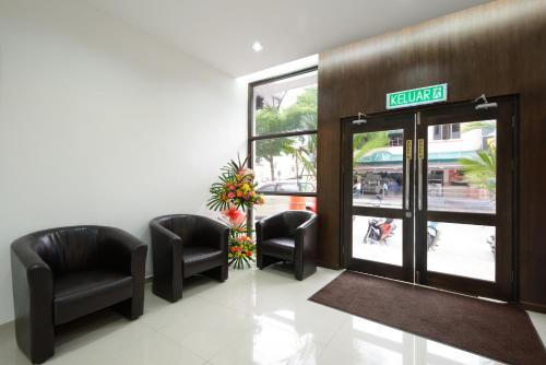 a waiting room with chairs and a sign on the door at Grand Inn - Penang Road in George Town