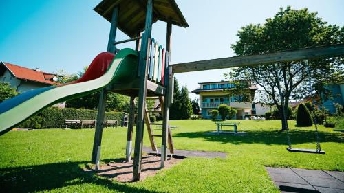a playground with a slide in a park at Karglhof Villa in Faak am See