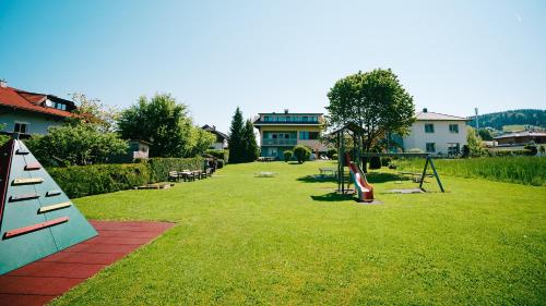 a park with a swing set and a playground at Karglhof Villa in Faak am See