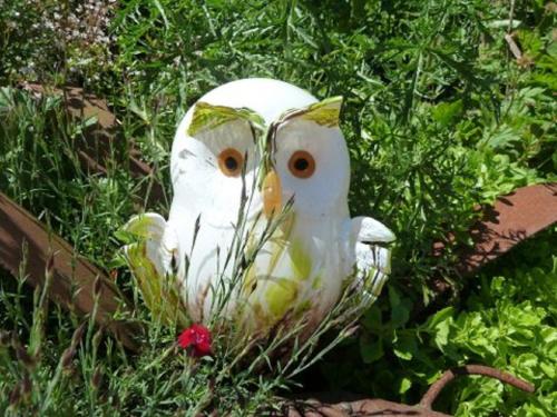 a white owl statue sitting in the grass at Gästehaus Fidelis in Grafenwiesen