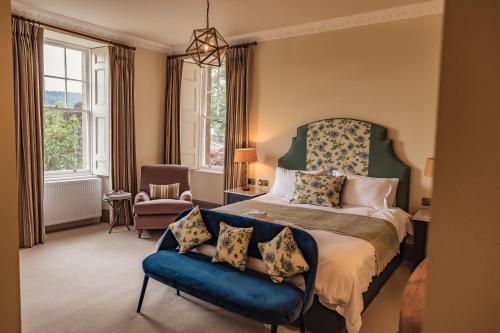 a bedroom with a bed and a blue couch at Tay House in Dunkeld