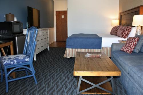a hotel room with a bed and a couch at Avenue Inn & Spa in Rehoboth Beach