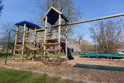 a playground with a slide in a park at Hotel La Passerelle in Grandhan