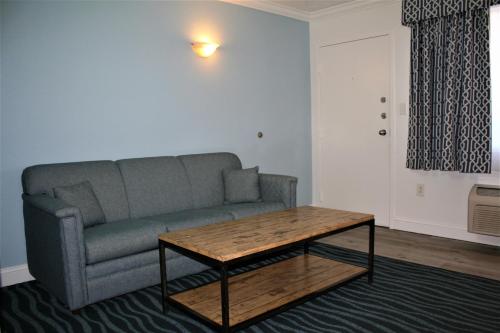 a living room with a couch and a coffee table at Avenue Inn & Spa in Rehoboth Beach