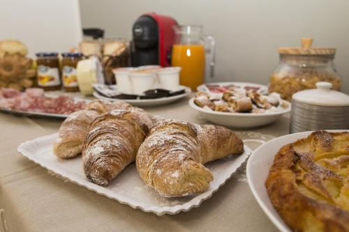 a table with croissants and other breakfast foods on it at La Dimora Di Segesta B&B in Calatafimi