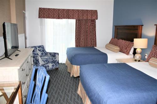 a hotel room with two beds and a television at Avenue Inn & Spa in Rehoboth Beach