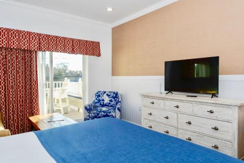 a bedroom with a bed and a television on a dresser at Avenue Inn & Spa in Rehoboth Beach