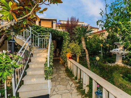 a stairway leading up to a house with plants at Apartments Roda in Supetar