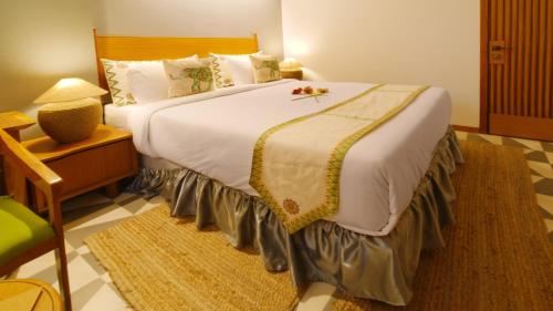 a large bed in a hotel room with a bed sidx sidx at Hotel Nova Boutique in Rajkot