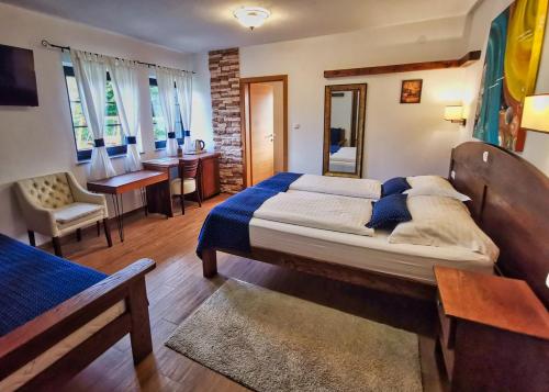 a bedroom with a large bed and a dining room at Plitvice Luxury Etno Garden in Plitvička Jezera