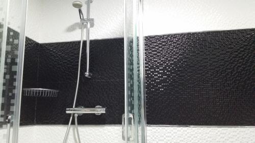 a shower with a glass door in a bathroom at Vacanza Complex in Benidorm
