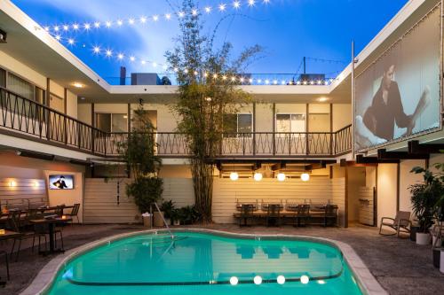 a swimming pool in the courtyard of a building with a house at The Pearl Hotel in San Diego