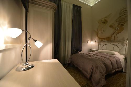 a room with a bed and a lamp on a table at Conte di Cavour in Foggia