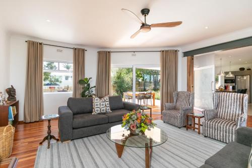 a living room with a couch and a table at Paradise on Ridge in Knysna