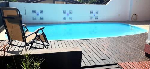 a swimming pool with two chairs and a chair next to it at Casa Ribeirao da Ilha in Florianópolis