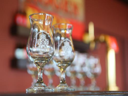three wine glasses sitting on top of a table at Ryokan Biyunoyado in Yamanouchi