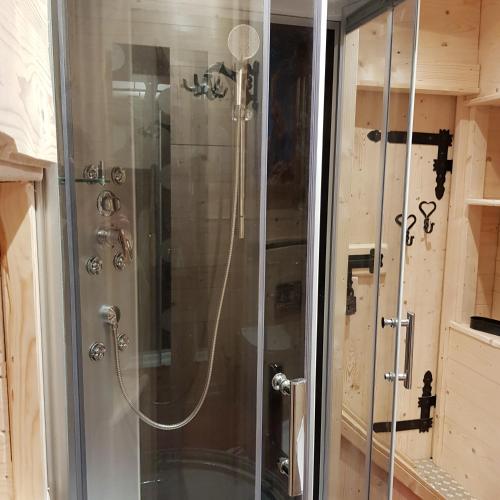 a shower with a glass door in a bathroom at Home&Classic Erlebnisscheune in Effelder