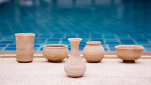 a group of wooden vases sitting on a table at The Mangrovetree Sanya Resort in Sanya
