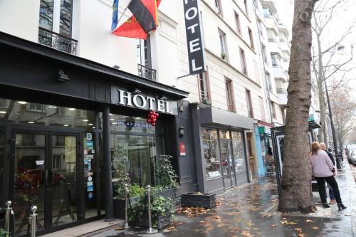 a woman walking down a street in front of a store at Grand Hotel Nouvel Opera in Paris