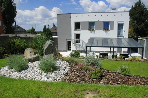 a white house with a garden in front of it at Výšinka 719 in Turnov