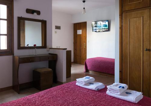 a bedroom with a sink and towels on the floor at Drymna in Trizonía