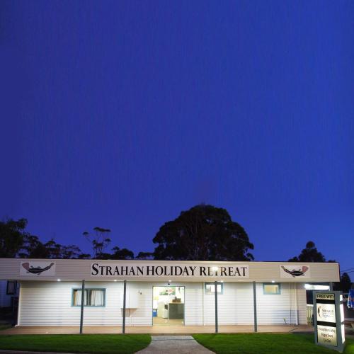 a building with a sign that reads strarian holiday riser at Strahan Retreat Holiday Park in Strahan