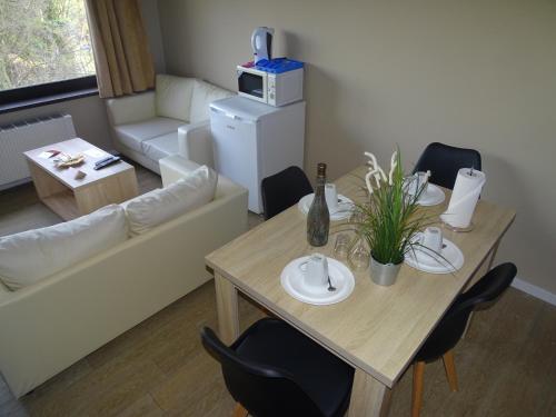 a living room with a table and chairs and a couch at Budget Flats Brussels in Brussels