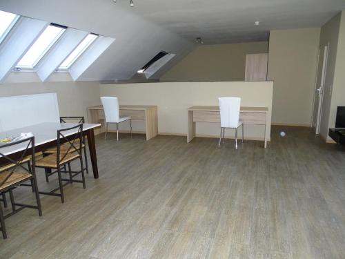 a room with tables and white chairs and skylights at Budget Flats Brussels in Brussels