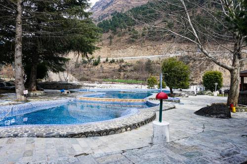 a swimming pool with a red ball in the middle at Apple Valley Resort in Kulu