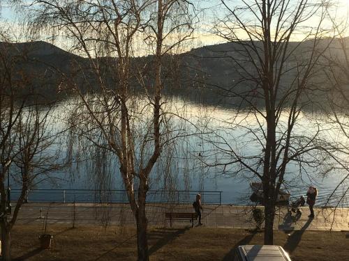 a view of a body of water with people on a bench at CK Lake View in Kastoria