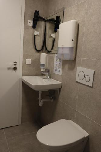a bathroom with a toilet and a sink at Höfn Hostel in Höfn