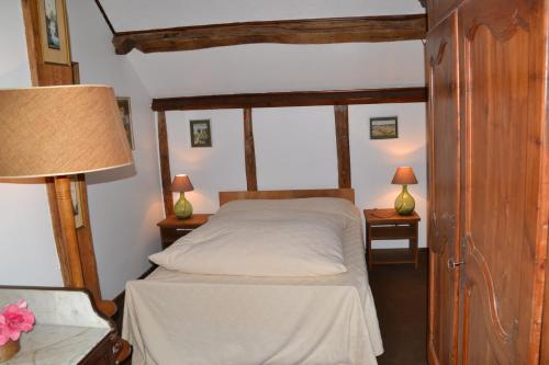 ショーモン・シュル・ロワールにあるGite de la Ronceraieのベッドルーム1室(ベッド1台、ランプ付きテーブル2台付)