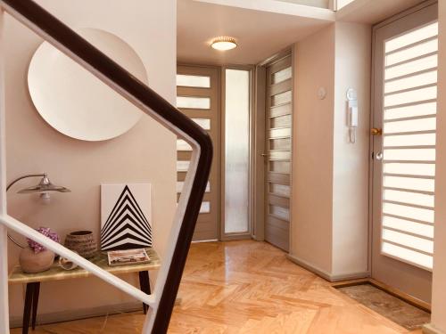 a hallway with a staircase with a table and a door at INCREDIBLE DUPLEX PENTHOUSE & TERRACES & Parking in Porto