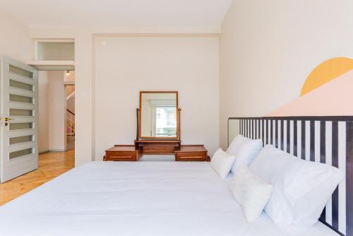 a bedroom with a white bed and a mirror at INCREDIBLE DUPLEX PENTHOUSE & TERRACES & Parking in Porto