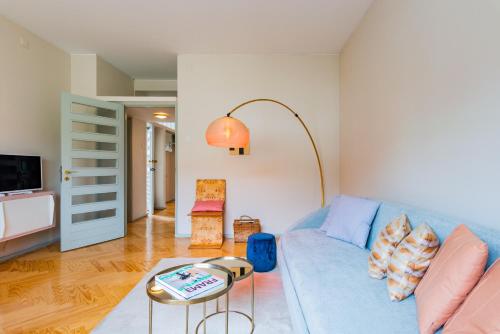 a living room with a blue couch and a table at INCREDIBLE DUPLEX PENTHOUSE & TERRACES & Parking in Porto