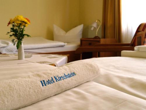 a hotel room with a towel on the bed at Hotel Pension Kirschstein in Wolgast