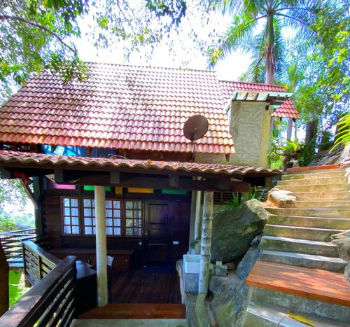 a small house with stairs leading up to it at Langit Rimba Resort in Seremban