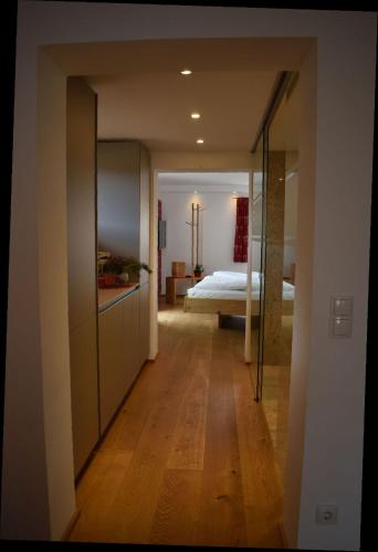 a hallway leading to a bedroom with a bed at Bucherhof in Obsteig