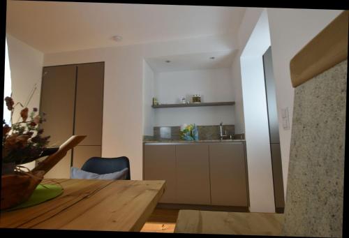a kitchen with a wooden table and a dining room at Bucherhof in Obsteig