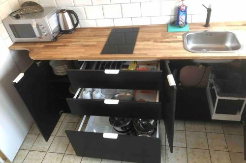 a kitchen with a sink and a wooden counter top at Hauckwald Apartment 2 in Alzenau in Unterfranken