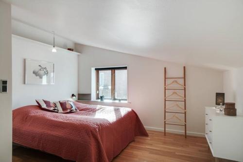 a white bedroom with a bed and a window at Marieshus in Holstebro