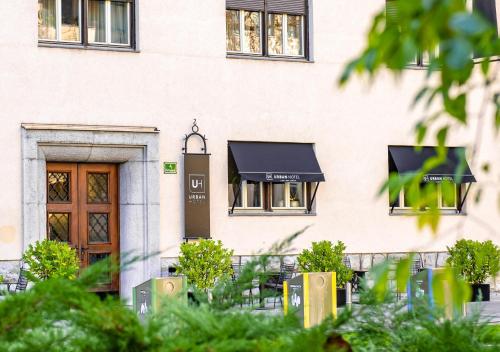 a building with a black awning on it at Urban Boutique Hotel Center in Ljubljana