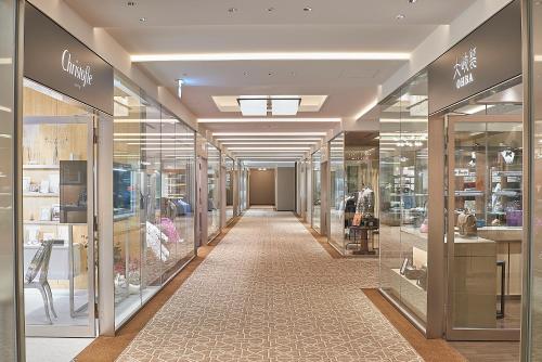 a hallway of a store with many glass windows at The Okura Tokyo in Tokyo